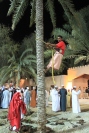 Omani man from Suwaiq demonstrates how they collect dates at the Muscat Festival